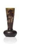 a vase with a tree on it sitting on a table
