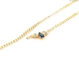 a gold chain with a blue stone on it