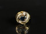a gold ring with a blue sapphire and diamonds