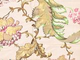 a close up of a floral fabric with a bird on it