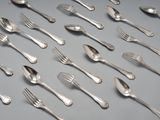 a lot of silver spoons and forks on the table