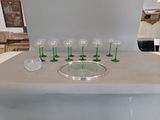 bottles and glasses on a table with a tray on top of it