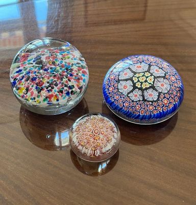 three glass bowls sitting on a table next to each other