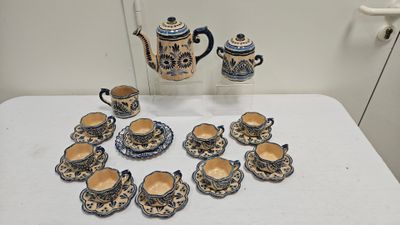 a table with a bunch of cups and saucers on it