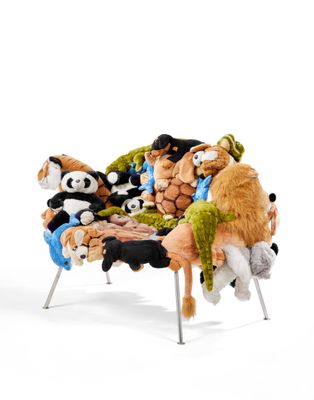 many stuffed animals that are sitting on a chair