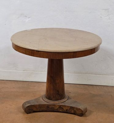 an image of a wooden table with a marble top on a hard wood floor