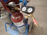 a fire hydrant on a cart with two gauges on it
