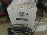 a machine that is sitting on the floor next to a fan