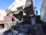 a dump truck that is sitting on the side of the road
