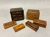 four small wooden boxes and a small wooden box on a white surface