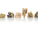 an image of a group of carved figurines on a white surface