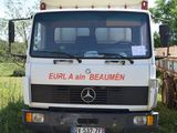 a white truck that is parked in the grass
