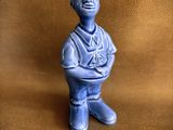 a small blue figurine of a man with a hat on