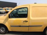 a yellow van that is parked in a parking lot
