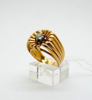 a close up of a gold ring with a diamond on it