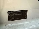 a volkswagen logo on the back of a white car