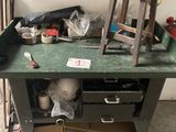 a workbench with a lot of clutter on it