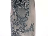 a silver vase with a skull and crossbone design on it