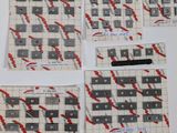 several pieces of white and black tile with red and white designs