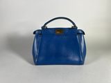 a blue handbag on a white background