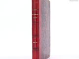 a red book sitting on top of a white table