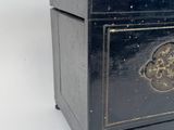 a small black box with a gold design on it