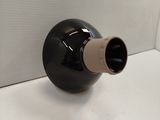 a black and white vase on a white table
