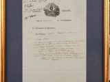 framed photograph of a letter signed by a man in a suit and tie