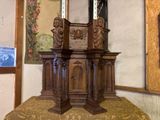 a small wooden table with a mirror on top of it