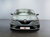 the front view of a grey car parked in a showroom