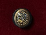 a gold and black clock on a red velvet surface