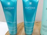 two tubes of hair products are sitting on a wooden board