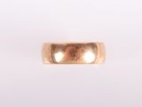 gros plan d'une bague en or sur fond blanc