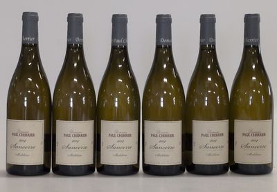six bottles of wine are lined up in a row on a table