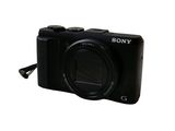 a black camera that is sitting on a white surface