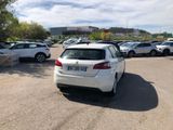 a white car parked in a parking lot next to other cars