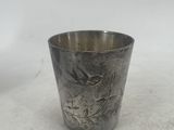 a silver cup that is sitting on a table
