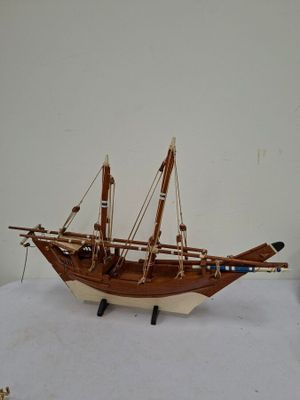 a wooden model of a boat on a table