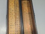 an old wooden box that has a ruler in it