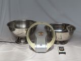 a silver bowl and a silver bowl on a table
