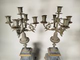 pair of antique silver candelabs on marble pedestals
