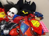 a pile of assorted costumes and masks on the floor
