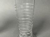 a glass with a spiral design on it on a table