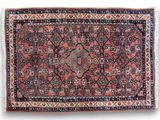 an antique persian rug with a red and blue design
