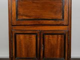 an old wooden cabinet with two doors and two drawers