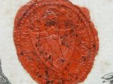 a red wax seal on a piece of paper with a bird on it