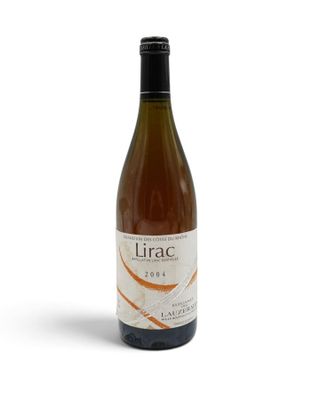 a bottle of wine sitting on top of a white table