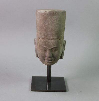 sculpture of a head on a stand with a white background