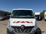 a white van parked in a parking lot with other vehicles in the background