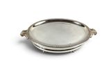 an oval silver tray with handles and handles on a white background